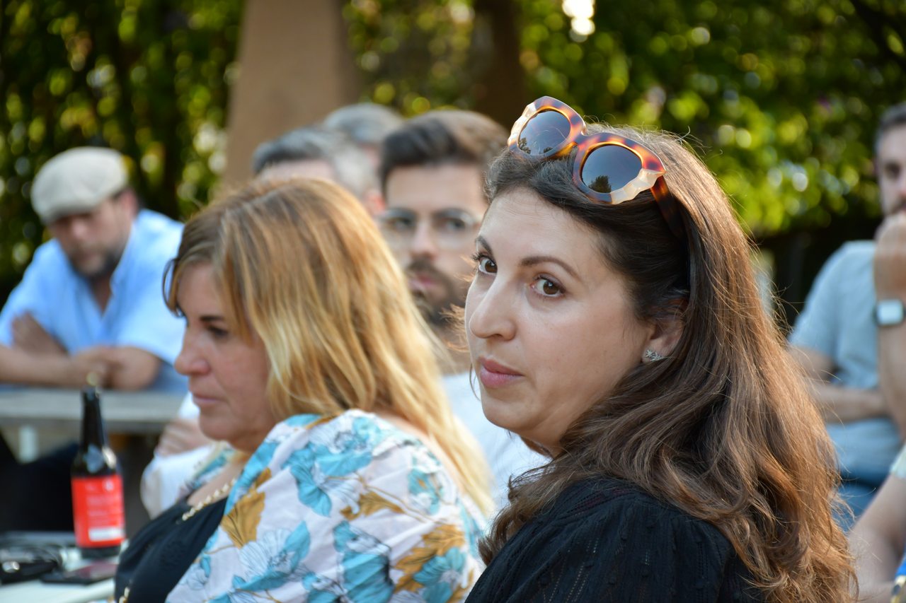 Participants turn toward one another during an outdoor exchange at Diáspora